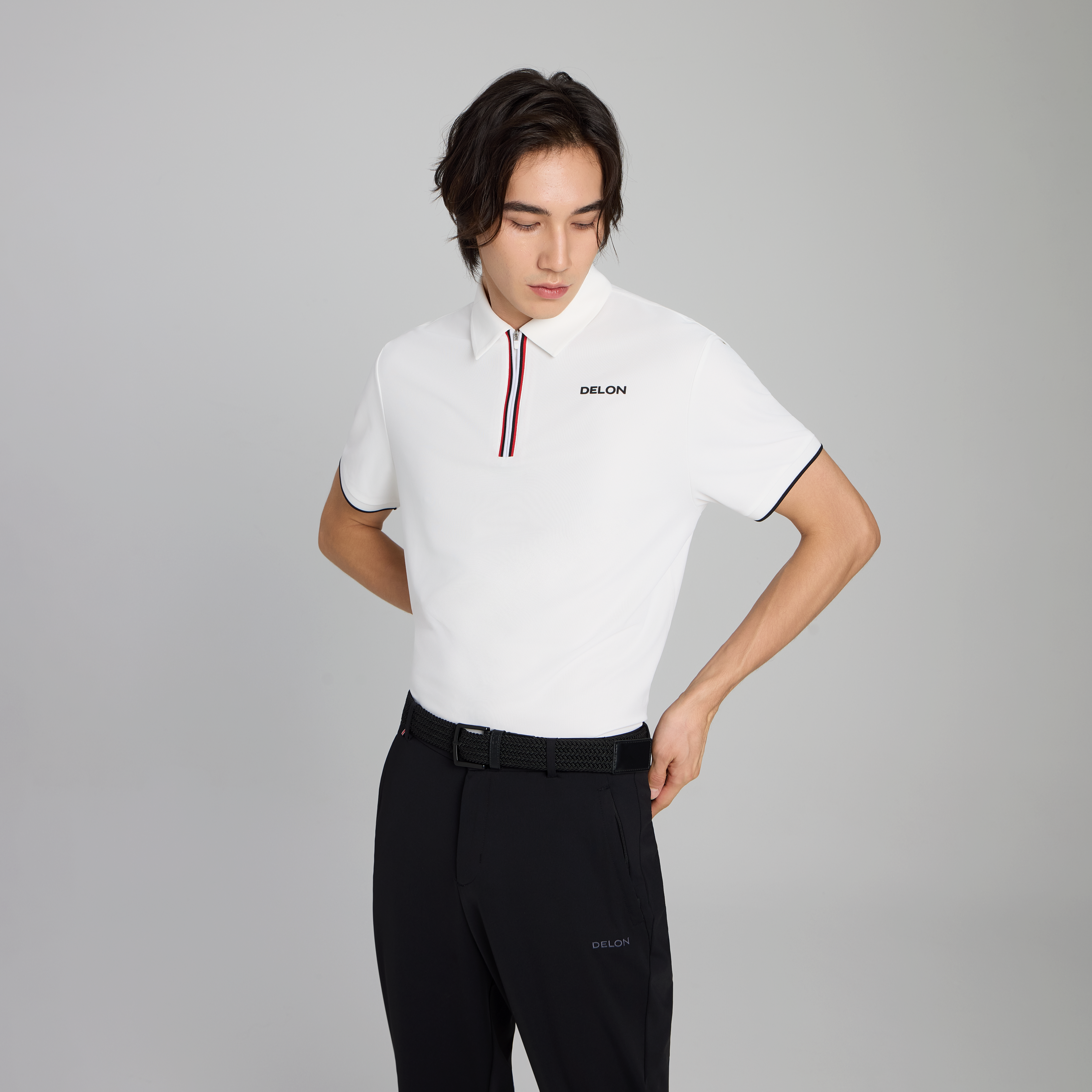 DELON Men's Dynamic Zipper Performance Polo in white, featuring a modern quarter-zip placket and premium dual-colored piping.