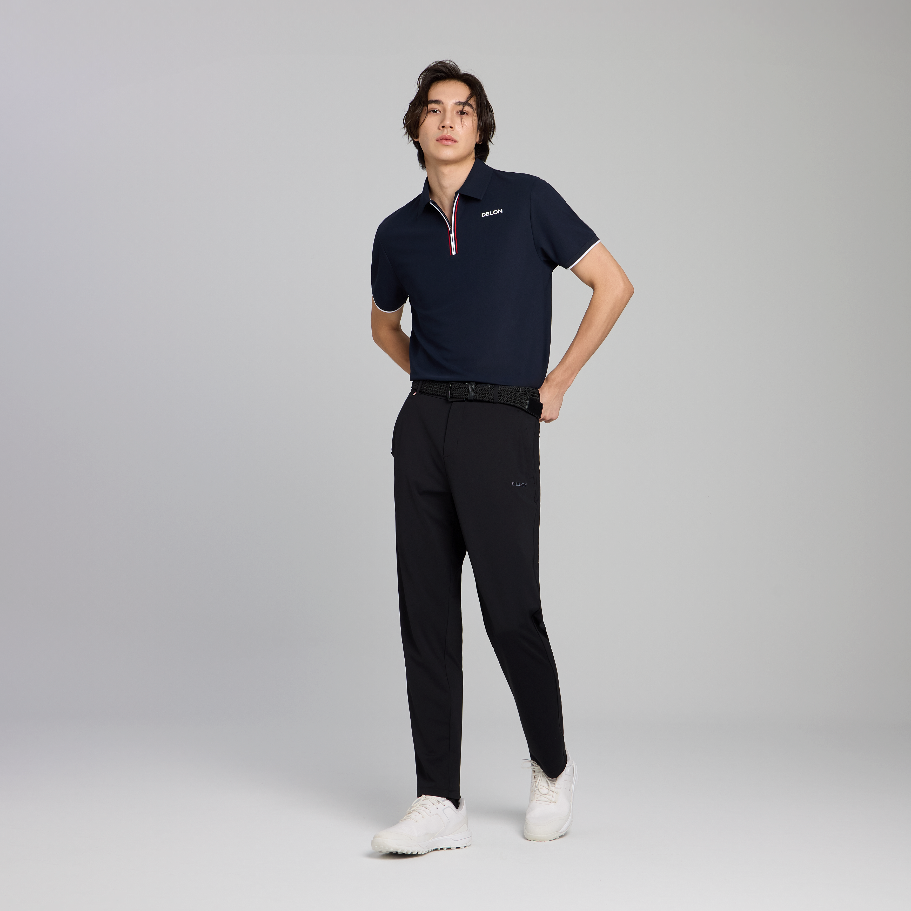 Model wearing DELON luxury athletic polo shirt, showcasing a tailored regular fit for golf, tennis, and padel